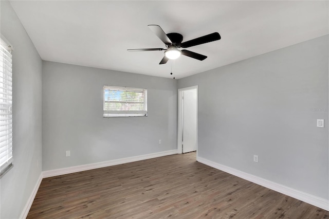 empty room featuring ceiling fan and dark wood-type flooring