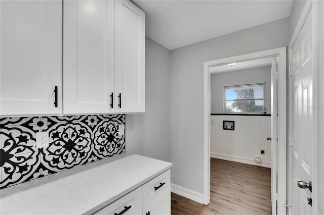 mudroom featuring wood finished floors and baseboards