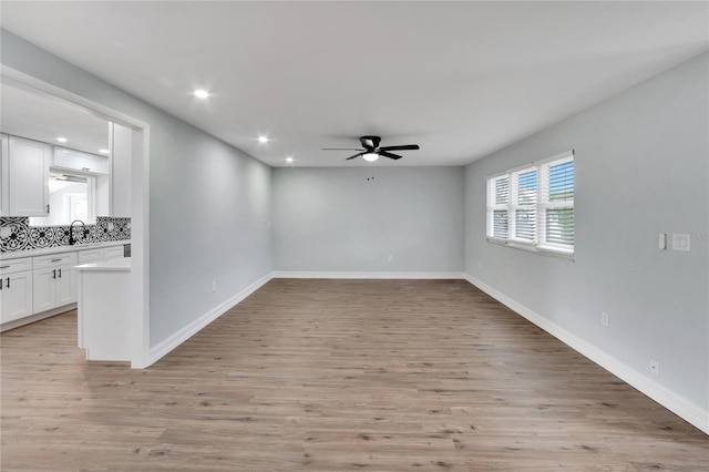 unfurnished room featuring light wood finished floors, baseboards, recessed lighting, and ceiling fan