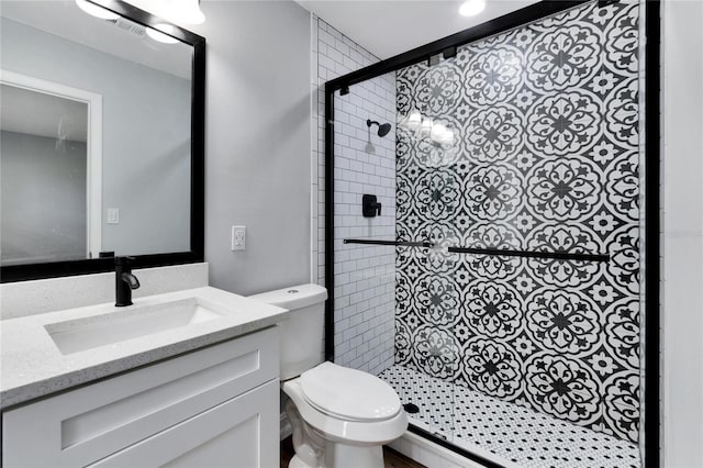full bathroom with vanity, toilet, a stall shower, and visible vents