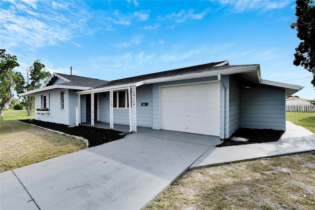 ranch-style home with a porch, concrete driveway, a front lawn, and a garage