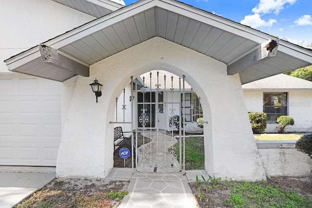 view of exterior entry featuring a garage