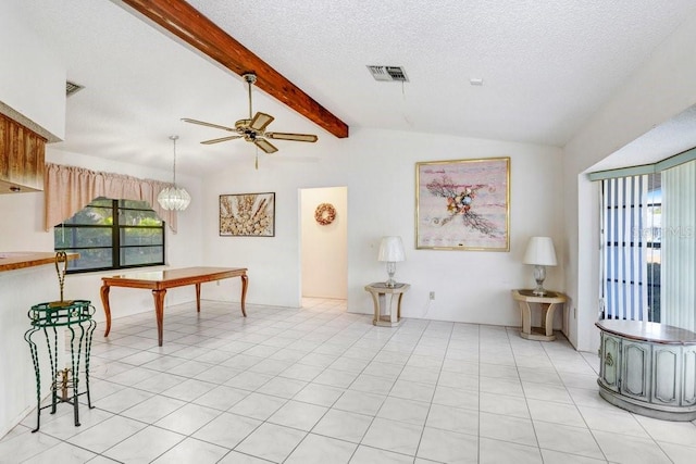 living room featuring vaulted ceiling with beams, ceiling fan, a textured ceiling, and a wealth of natural light