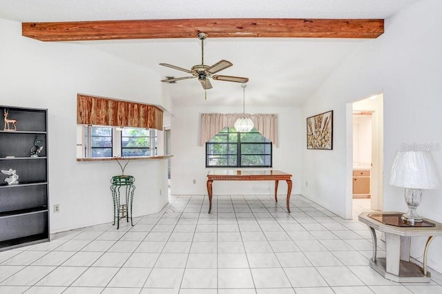 interior space featuring ceiling fan and lofted ceiling with beams