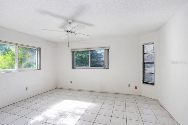 spare room featuring a textured ceiling and ceiling fan