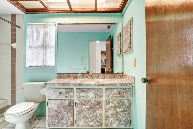 bathroom featuring tile patterned flooring, vanity, and toilet