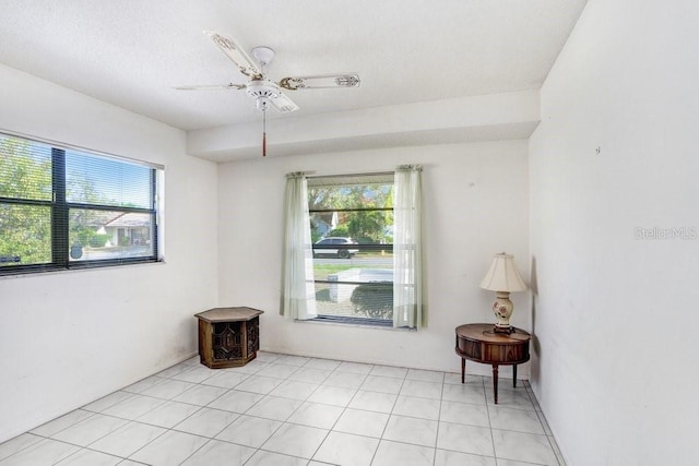 unfurnished room featuring a wealth of natural light and ceiling fan