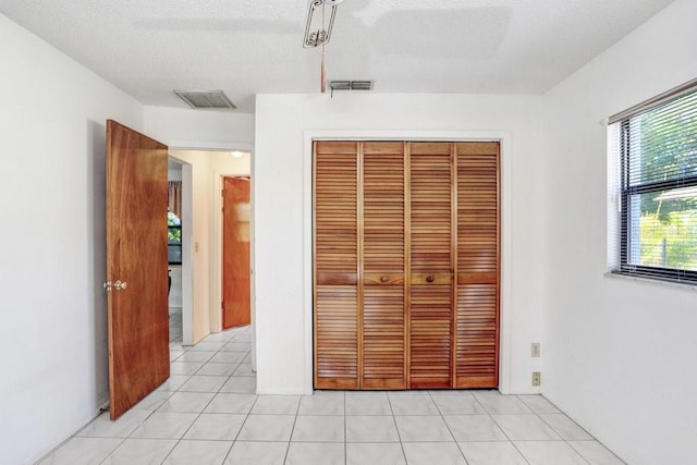 unfurnished bedroom with a closet and a textured ceiling