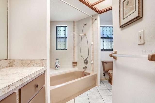 full bathroom featuring toilet, tile patterned flooring, vanity, and tiled shower / bath