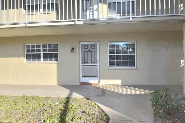 doorway to property featuring a balcony and a patio