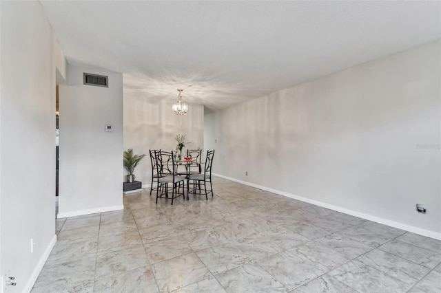 dining space featuring a chandelier