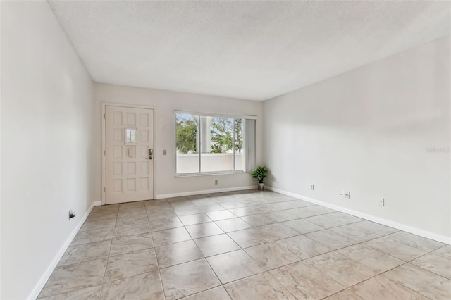 empty room featuring a textured ceiling