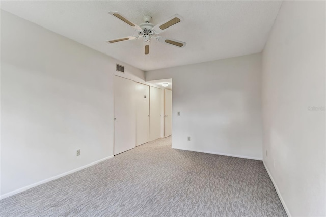 unfurnished room featuring ceiling fan and light colored carpet