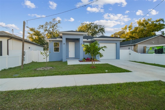 view of front of home with a garage and a front lawn