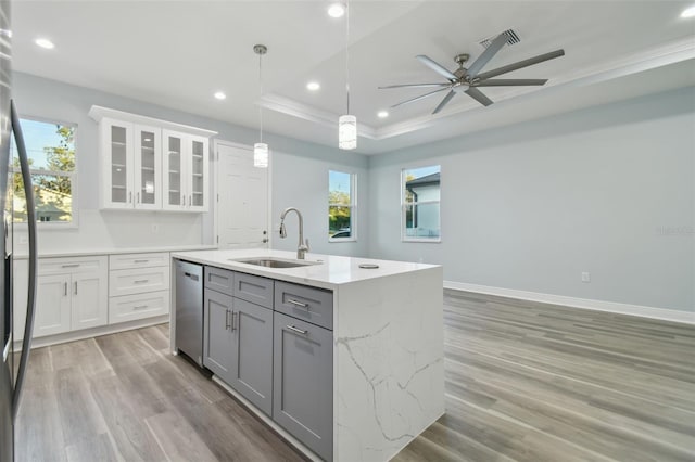 kitchen featuring dishwasher, decorative light fixtures, white cabinetry, and sink