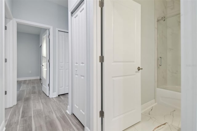 corridor with light hardwood / wood-style floors