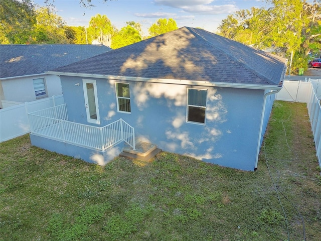 rear view of property with a yard