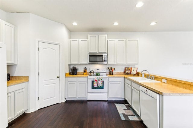 kitchen with white cabinetry, sink, dark hardwood / wood-style floors, and white appliances