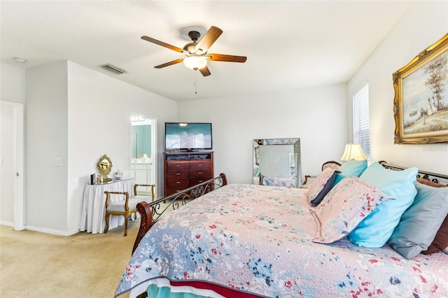 carpeted bedroom featuring ceiling fan and ensuite bathroom