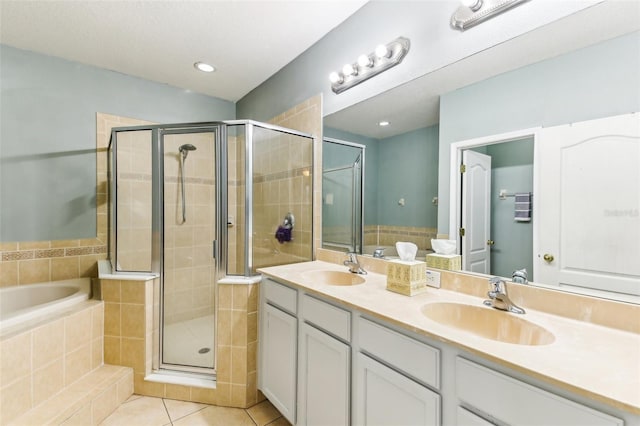 bathroom with tile patterned floors, vanity, and independent shower and bath