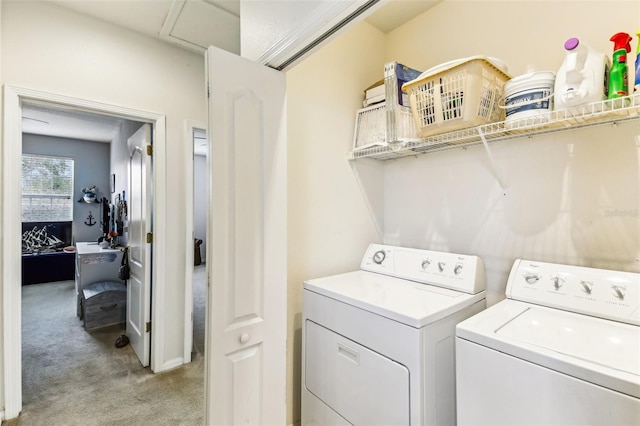 laundry room featuring washing machine and dryer and light colored carpet