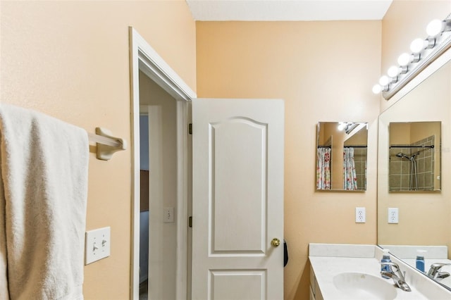 bathroom featuring vanity and curtained shower