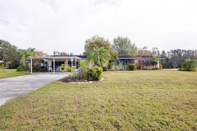 view of front facade with a front yard and a carport