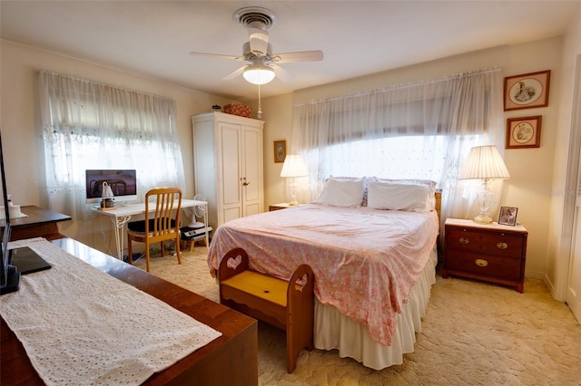 carpeted bedroom featuring ceiling fan and a closet