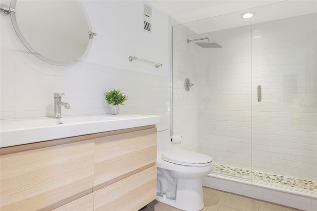 bathroom featuring decorative backsplash, tile patterned floors, walk in shower, tile walls, and toilet