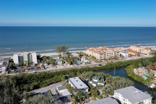 birds eye view of property with a water view and a beach view