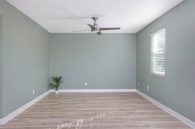 spare room featuring ceiling fan and light hardwood / wood-style floors