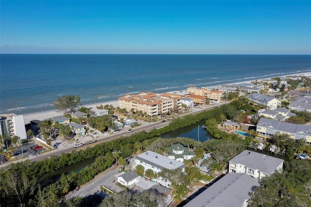 drone / aerial view with a water view and a beach view