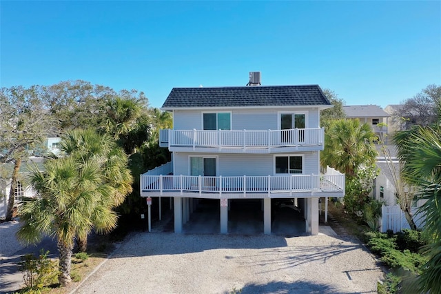 exterior space with a balcony and a carport