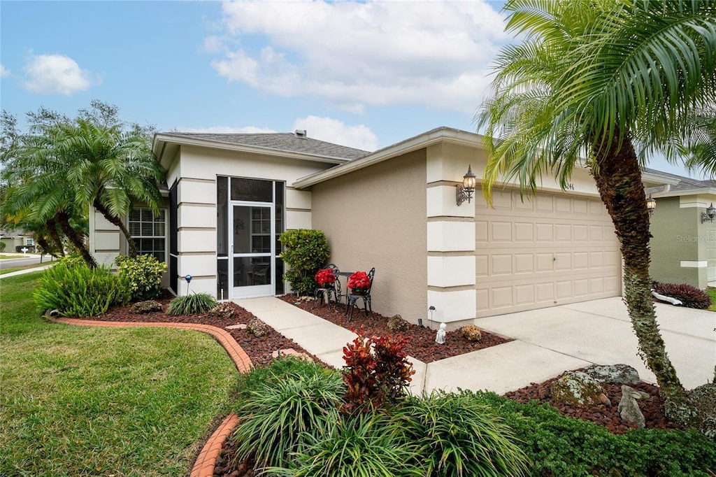 view of front of house featuring a garage and a front lawn