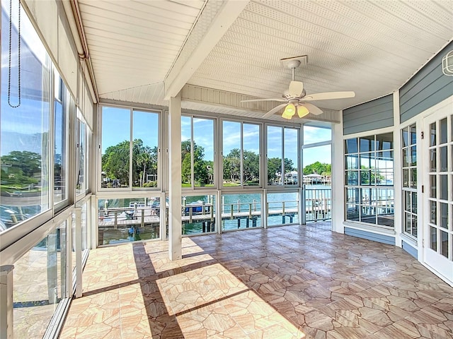 unfurnished sunroom featuring a water view and ceiling fan