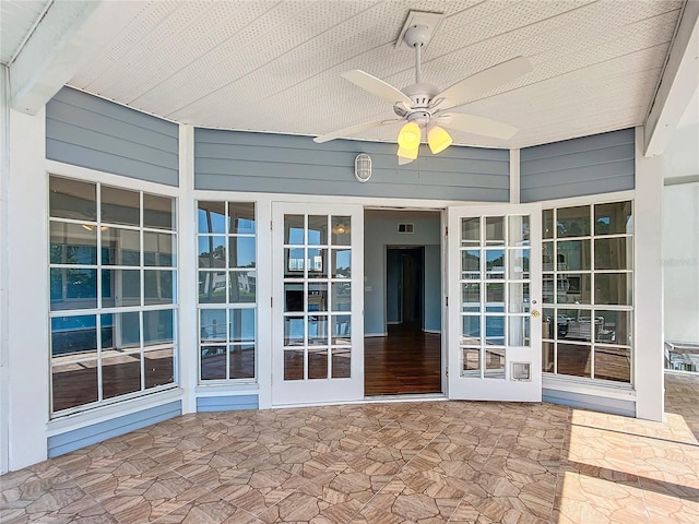 property entrance with ceiling fan, a patio, and french doors