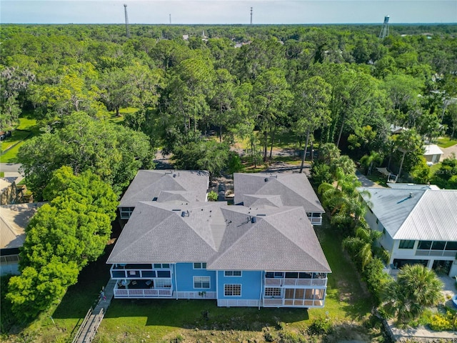 birds eye view of property featuring a wooded view