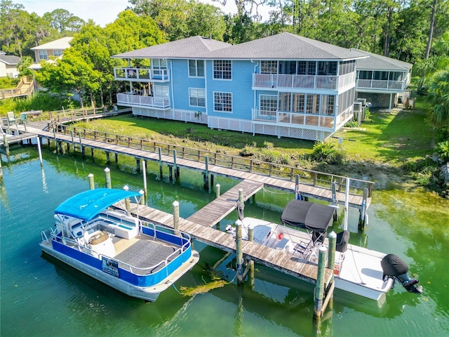 dock area featuring a water view and a yard