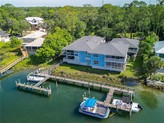 drone / aerial view featuring a water view and a wooded view