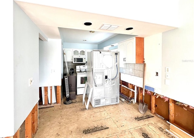 kitchen with tasteful backsplash, white appliances, visible vents, and white cabinets