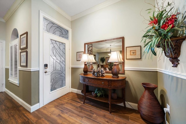 entrance foyer with dark hardwood / wood-style flooring and ornamental molding