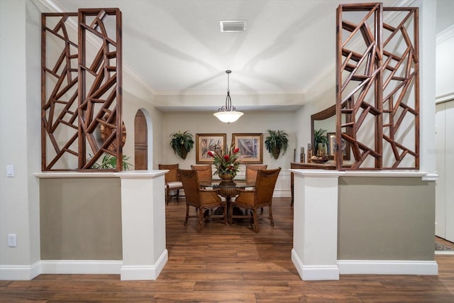 dining room featuring dark hardwood / wood-style floors and ornamental molding