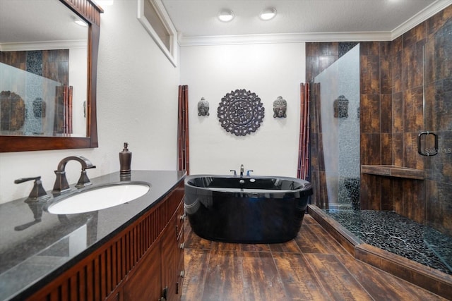 bathroom with separate shower and tub, vanity, hardwood / wood-style flooring, a textured ceiling, and ornamental molding