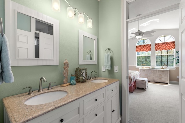 bathroom featuring ceiling fan, vanity, and lofted ceiling