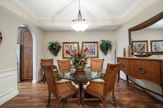 dining space featuring crown molding and dark hardwood / wood-style floors