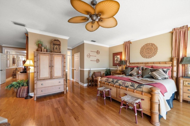 bedroom with ceiling fan, light hardwood / wood-style floors, and ornamental molding