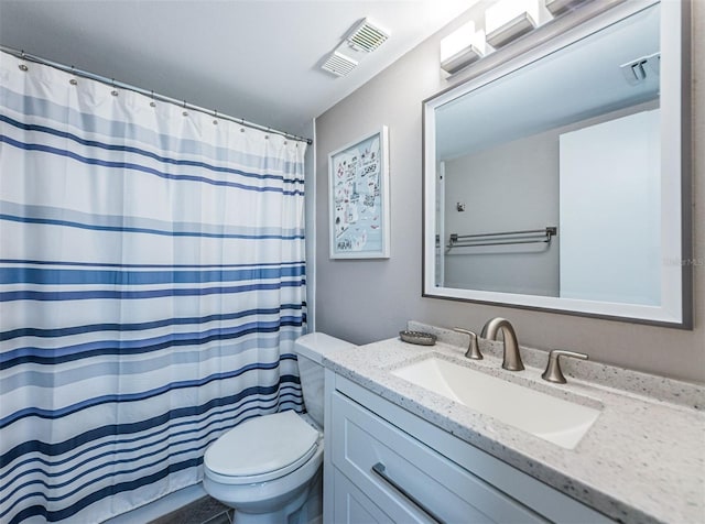 bathroom featuring vanity, toilet, and curtained shower