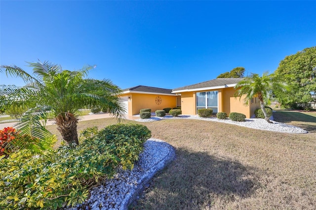 single story home with a front yard and a garage