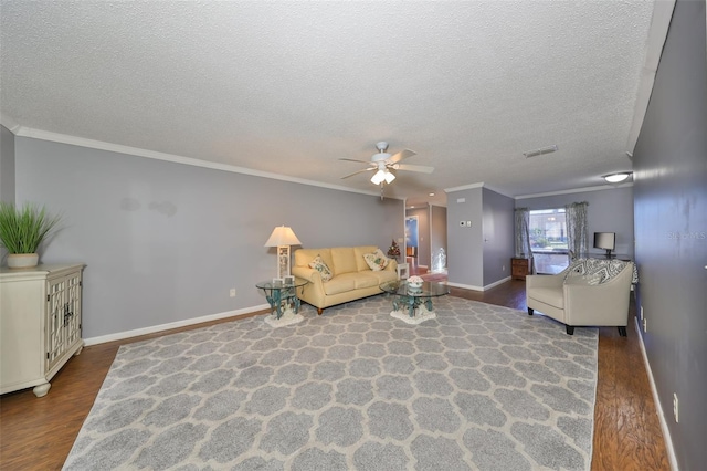 living room with hardwood / wood-style flooring, ceiling fan, ornamental molding, and a textured ceiling