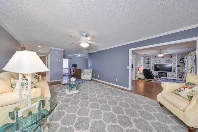 living room with crown molding, built in features, hardwood / wood-style floors, and a textured ceiling